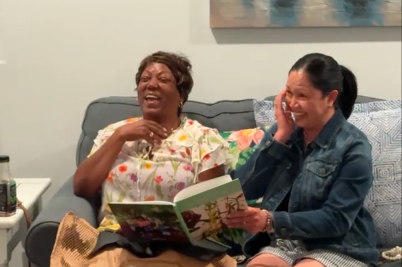 A My Stories Matter customer smiling while holding a finished memoir